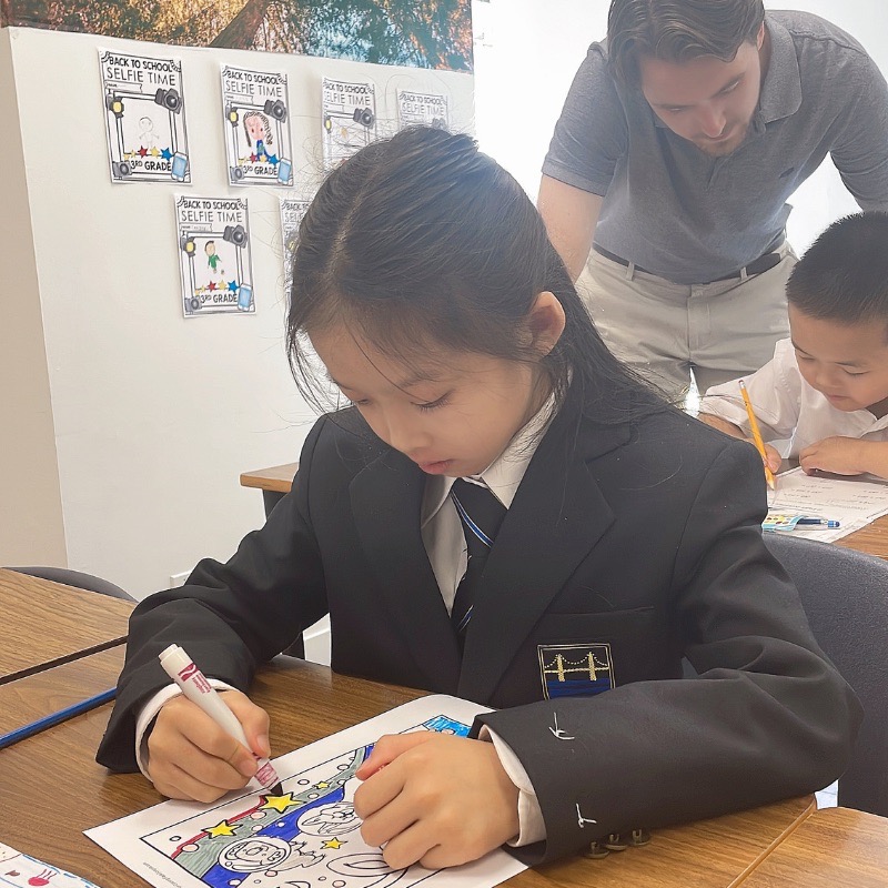 Kindergarten teacher giving individual attention in a small class at a downtown Vancouver school